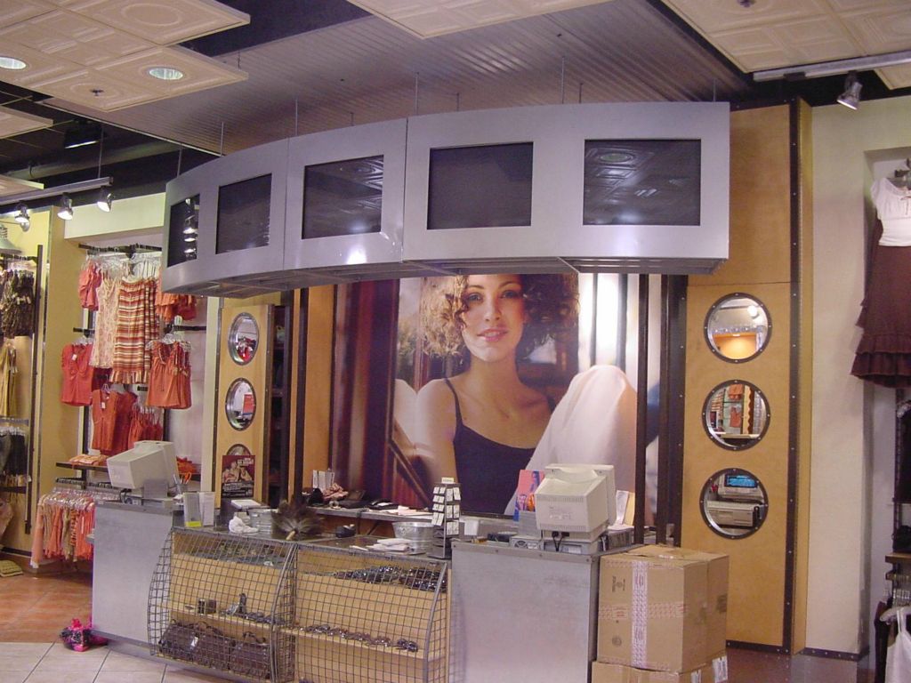 TVs MOUNTED in a STRUCTURAL CAGE SUSPENDED WITH ALL THREAD RODS TO THE CONCRETE STRUCTURE 18 FT ABOVE THE FLOOR